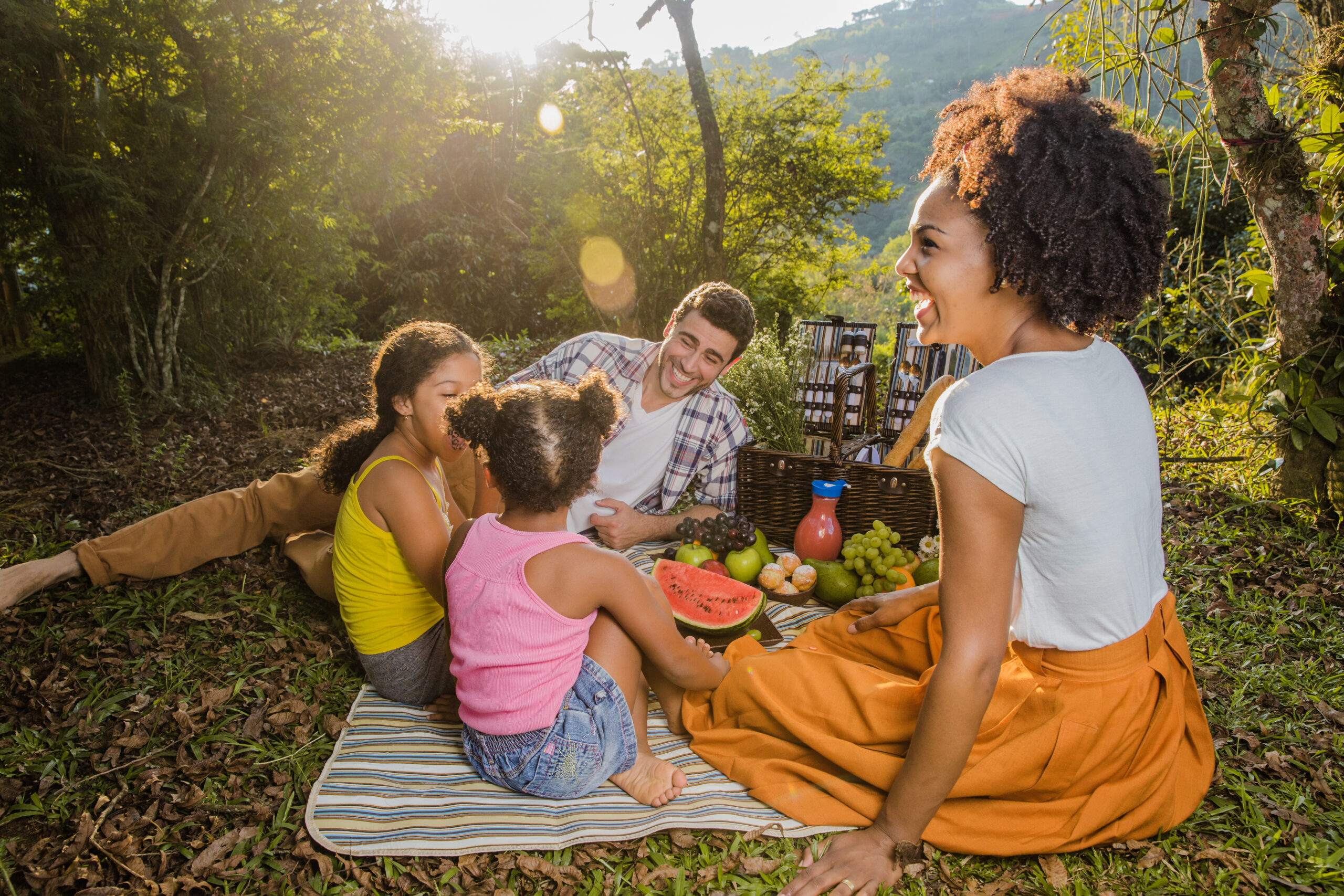 parents-with-two-daughters-having-picnic